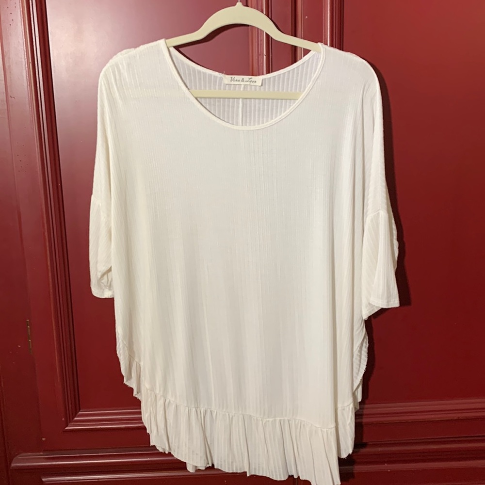 Ivory drop shoulder tunic with ruffles at bottom